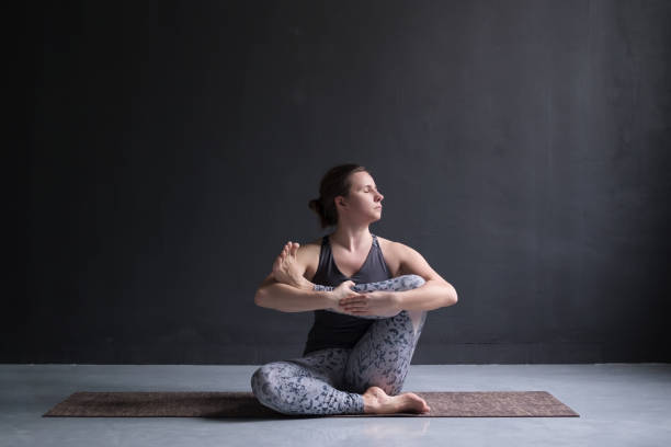 istock Woman working out, doing yoga exercise on floor, Needle hip stretch pose 1132761991