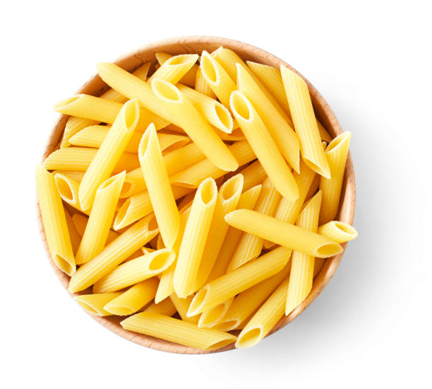Penne pasta or macaroni in a wooden bowl Delicious pasta or penne noodles, isolated on white background. Top view scene, healthy eating or healthy lifestyle. Penne pasta or macaroni in a wooden bowl, italian cuisine. penne stock pictures, royalty-free photos & images