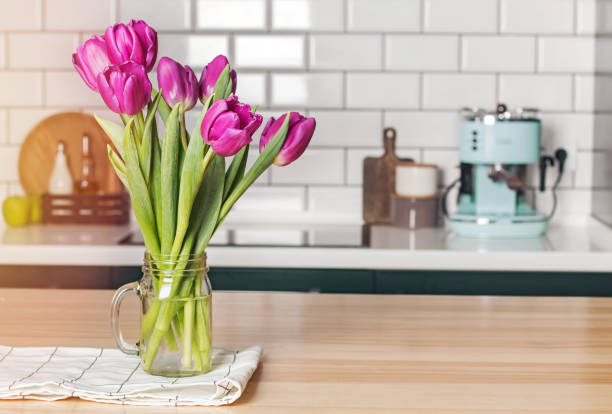 istock Purple tulips in a glass jar standing on the modern kitchen 1132763458