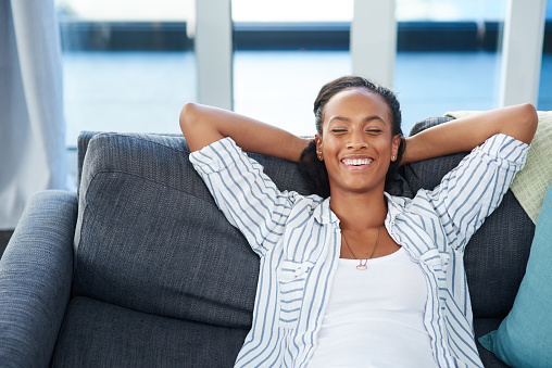 Shot of a young woman relaxing on the sofa at home