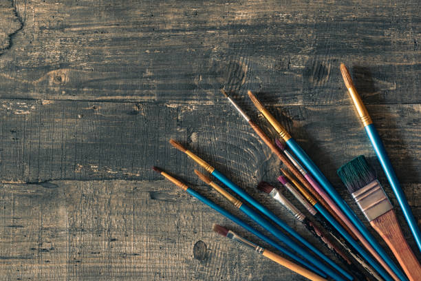istock Different brushes on dark wooden desk 1132766416