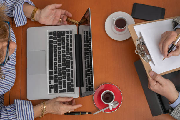 istock Top view of a businesswoman table with a man taking notes 1132769607