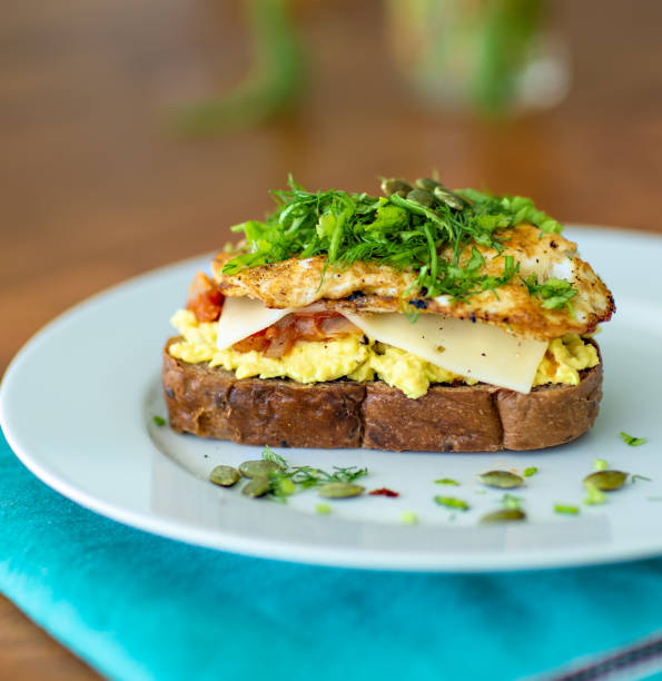 Breakfast sandwich with avocado and eggs on top