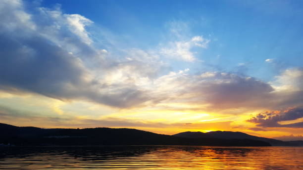 Bright sunset over the sea surface . Evening by the sea. Relaxation. Sunset on sea. Evening sunset, sea and sky