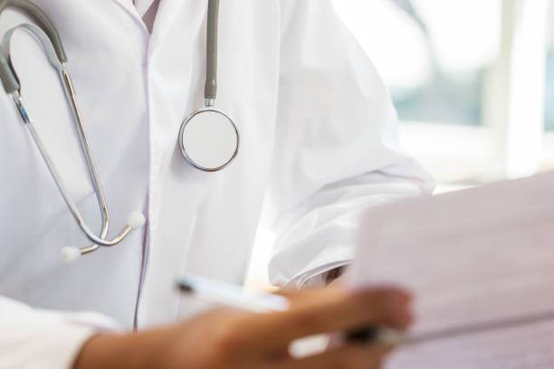 istock Female Doctor using tablet computer with white gown suite wearing Stethoscope on neck for seaching information treating patients in hospital or clinic, Healthcare medical concept 1132773493