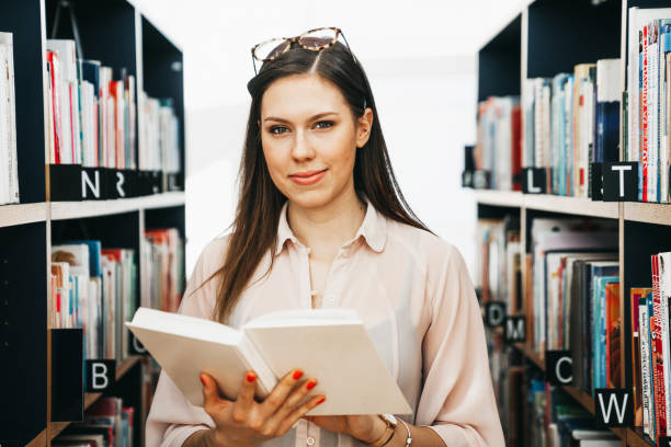 istock A happy girl in a library 1132774320