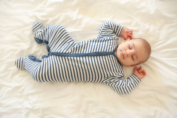 istock Baby sleeping on white quilt 1132774673