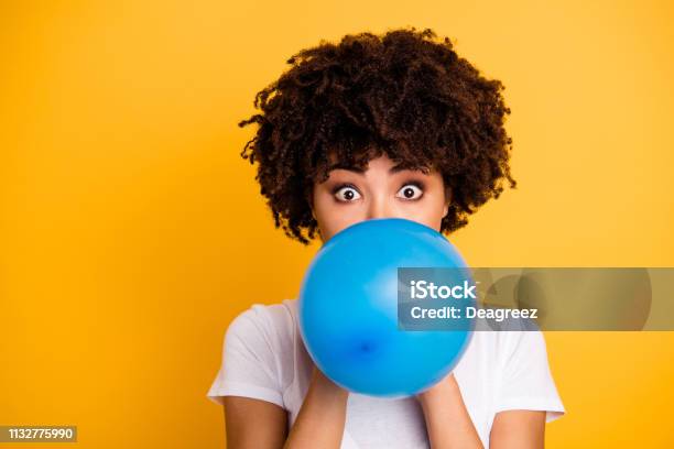 Close Up Photo Beautiful Amazing She Her Dark Skin Lady Hold Air Balloon Eyes Surprised Stupor Hiding Face Big Eyes Wear Casual White Tshirt Isolated Yellow Bright Vibrant Vivid Background Stock Photo - Download Image Now