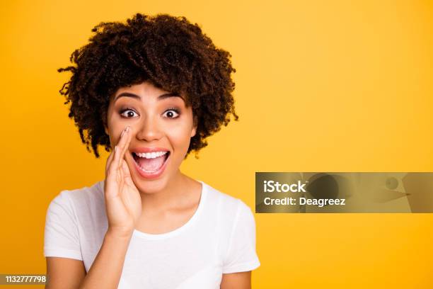 Close Up Photo Beautiful Amazing She Her Dark Skin Lady Hand Mouth Send Share Spread Information Messages Excited Wear Casual White Tshirt Isolated Yellow Bright Vibrant Vivid Background Stock Photo - Download Image Now