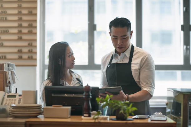 istock Mature baristas discussing over digital tablet 1132780771