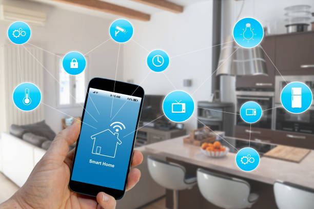 istock Hand holding smartphone with smart home application on screen 1132781698