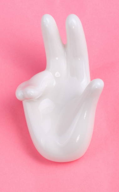 istock Ceramic stand with hand shape on pink background 1132782550