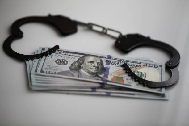 istock bribe corruption concept- handcuffs and dollars 1132784658