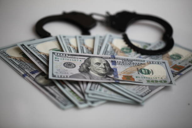 istock bribe corruption concept- handcuffs and dollars 1132784691
