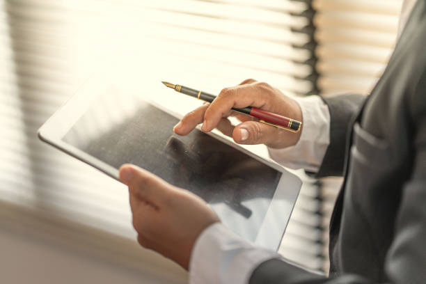 istock Businessman use computer tablet for work in communication around worldwide to success marketing plan of company 1132784711