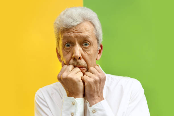 istock The senior man looking suprised isolated on color studio background 1132785822