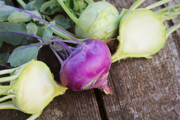 fresh kohlrabi on the wooden table closeup - kohlrabi imagens e fotografias de stock