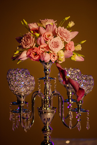 Formal table centerpiece, a beautiful crystal candelabra style candle holder with four hollow-carved designed bowls for candlesticks or tea light candles with a coral flowers vintage bouquet on top.