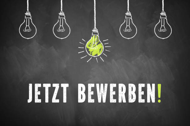istock chalk lightbulbs and the message  'Apply Now!' in German on a chalkboard 1132789046