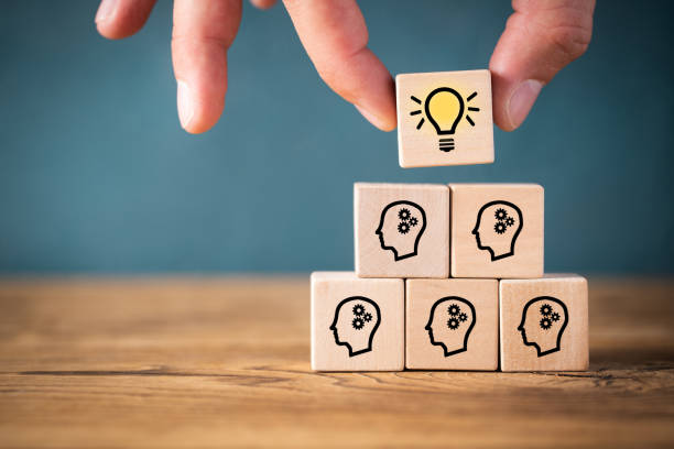 many people together having an idea symbolized by icons on cubes stock photo