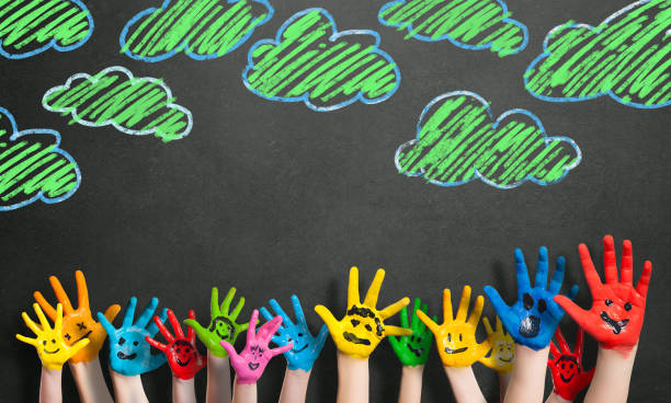 istock painted hands in front of a blackboard 1132789087
