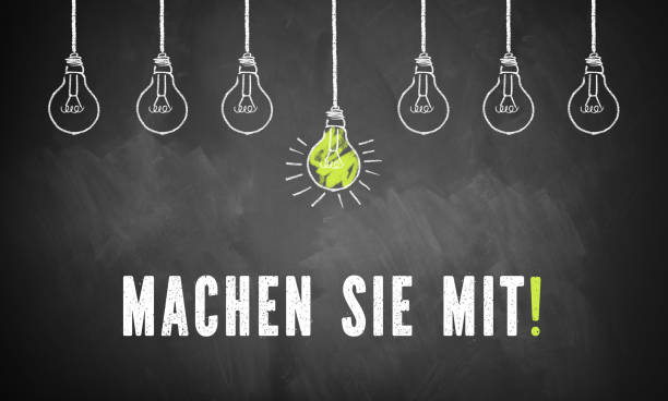 istock chalk lightbulbs and the message  'participate!' in German on a chalkboard 1132789196