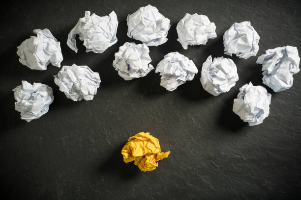 istock crumpled paper symbolizing different solutions with one standing out with a different color on slate background 1132790005