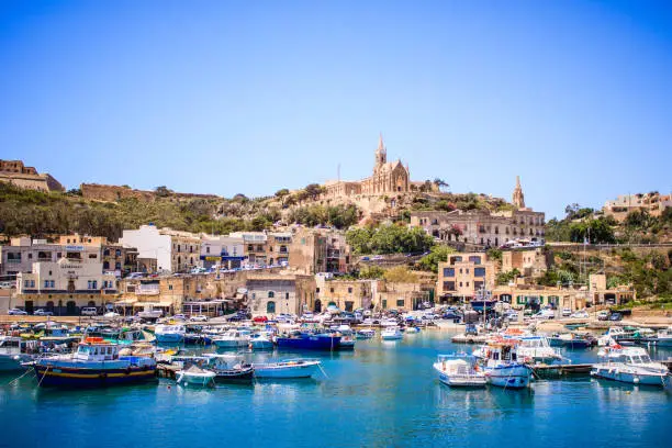 Beautiful view on Gozo island from a boat, postcard style, beautiful colors landscape, in the background you can see old buildings