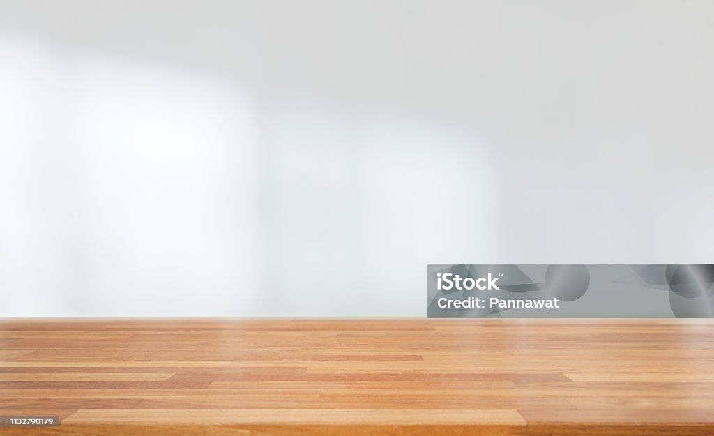Beautiful empty wood table against abstract blur white interior background Beautiful empty wood table against abstract blur white interior background, montage, product display, indoor and windows Table Stock Photo