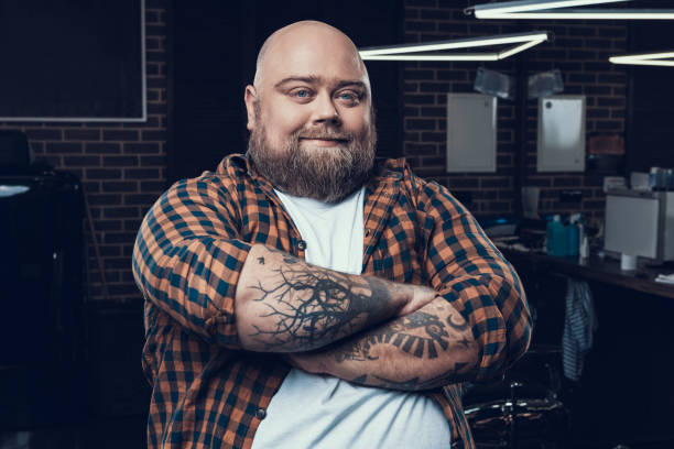 istock Calm man looking at camera and sitting in barber salon 1132790466
