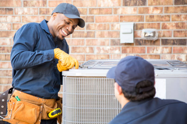 istock Multi-ethnic team of blue collar air conditioner repairmen at work. 1132790832