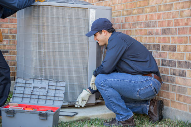 istock Multi-ethnic team of blue collar air conditioner repairmen at work. 1132791396