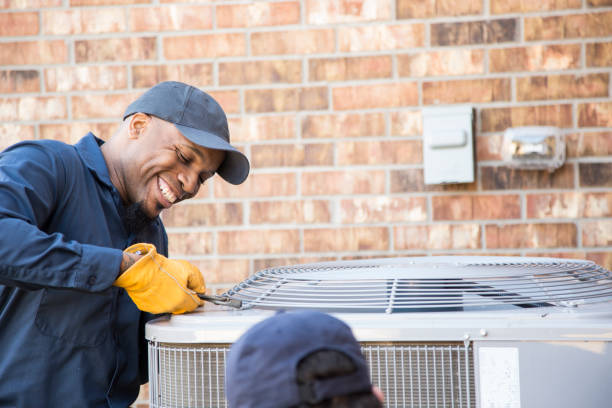 istock Multi-ethnic team of blue collar air conditioner repairmen at work. 1132791406