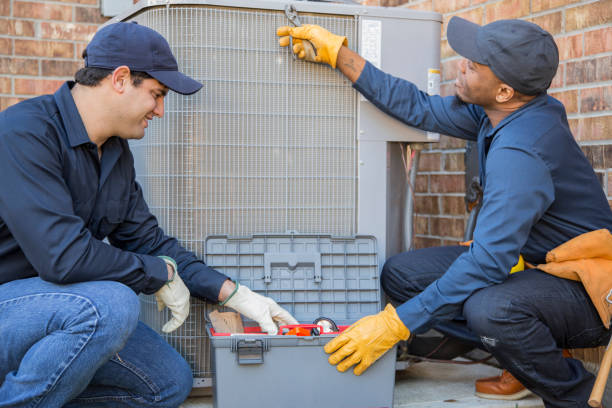 istock Multi-ethnic team of blue collar air conditioner repairmen at work. 1132791426