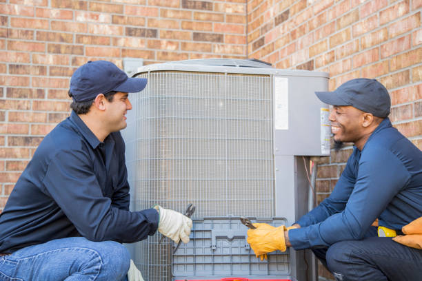 istock Multi-ethnic team of blue collar air conditioner repairmen at work. 1132791442