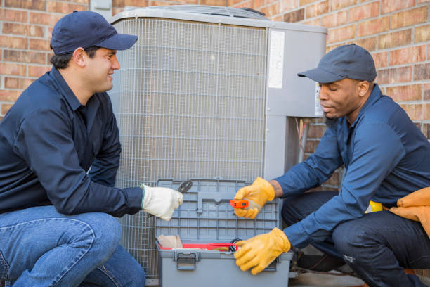 istock Multi-ethnic team of blue collar air conditioner repairmen at work. 1132791509