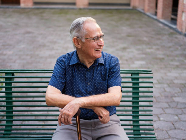 istock Latin elderly man sitting on a bench 1132793197