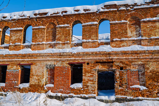 istock Old ruined red brick building against a blue winter sky 1132793214