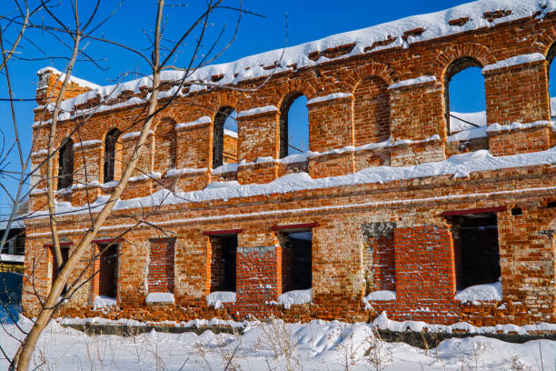 istock Old ruined red brick building against a blue winter sky 1132793218