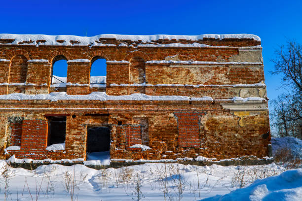 istock Old ruined red brick building against a blue winter sky 1132793220