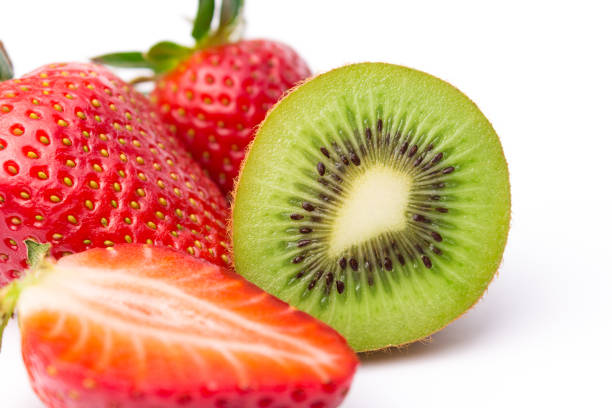 istock Halved kiwi fruit with straberries on white 1132795073