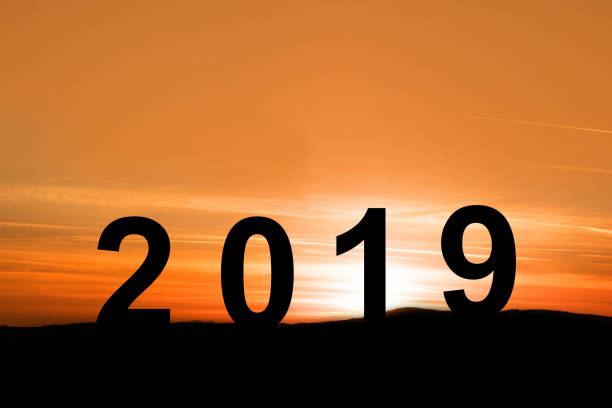 istock silhouette sunrise with words 2019 on the mountain 1132795884