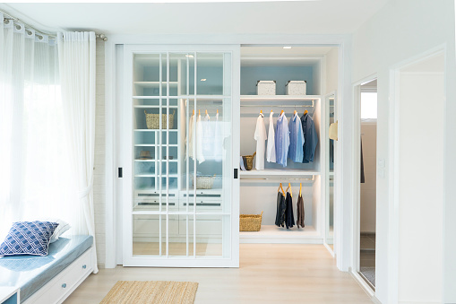 Stylish clothes and accessories in large wardrobe closet