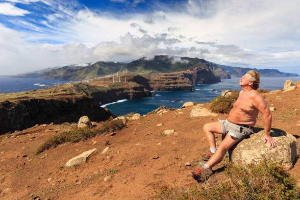 Tourist on the cliffs in the beautiful landscape of the east coast of the island Madeira at Ponta de Sao Lourenco nature reserve