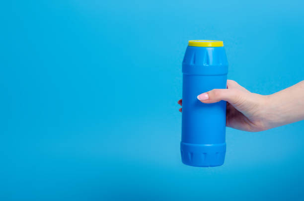 istock Blue bottle detergent powder in hand 1132796319