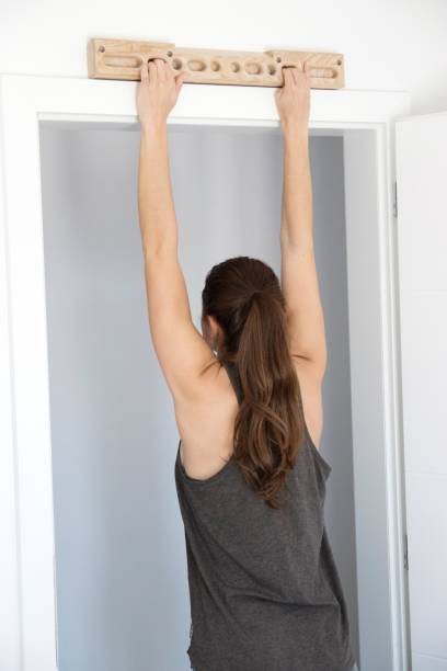 istock Woman climber training strength on fingerboard at home 1132796483