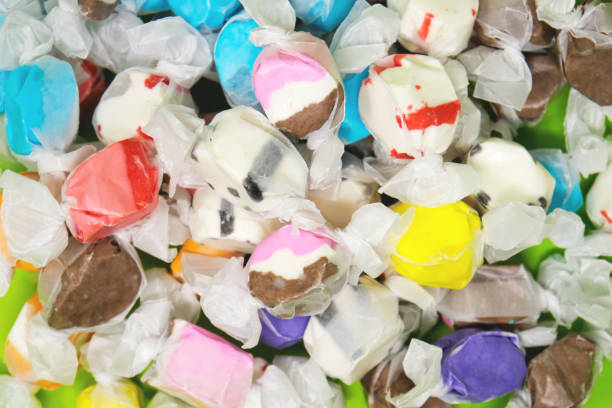 Taffy candy background. Taffy candy in wrapper, view from above of group. chewy stock pictures, royalty-free photos & images
