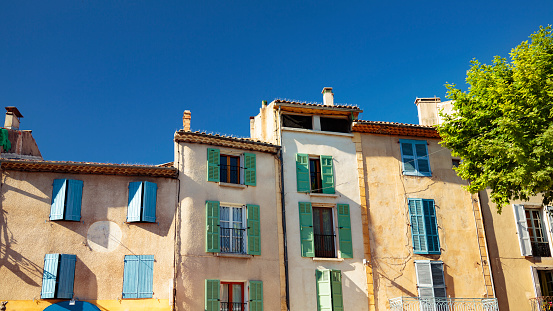 Typical provancal townhouses with window shutters in a small town in Provence, France