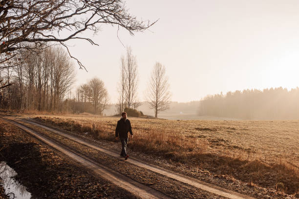 istock Man outdoors walking in spring nature landscape 1132798056