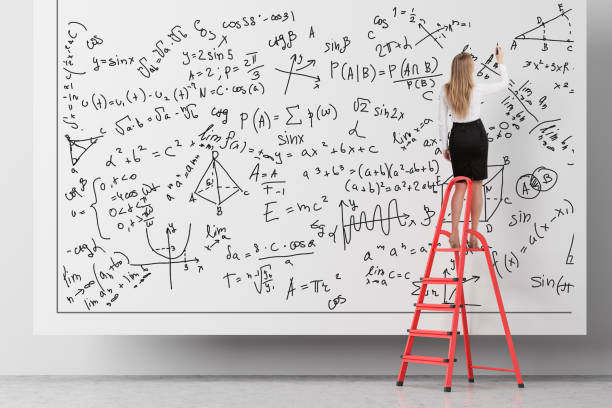 istock Woman on ladder writing formulas 1132798120